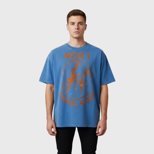 Man wearing a blue MOD 1 'Signal Rider" t-shirt with orange text and graphics on a plain background