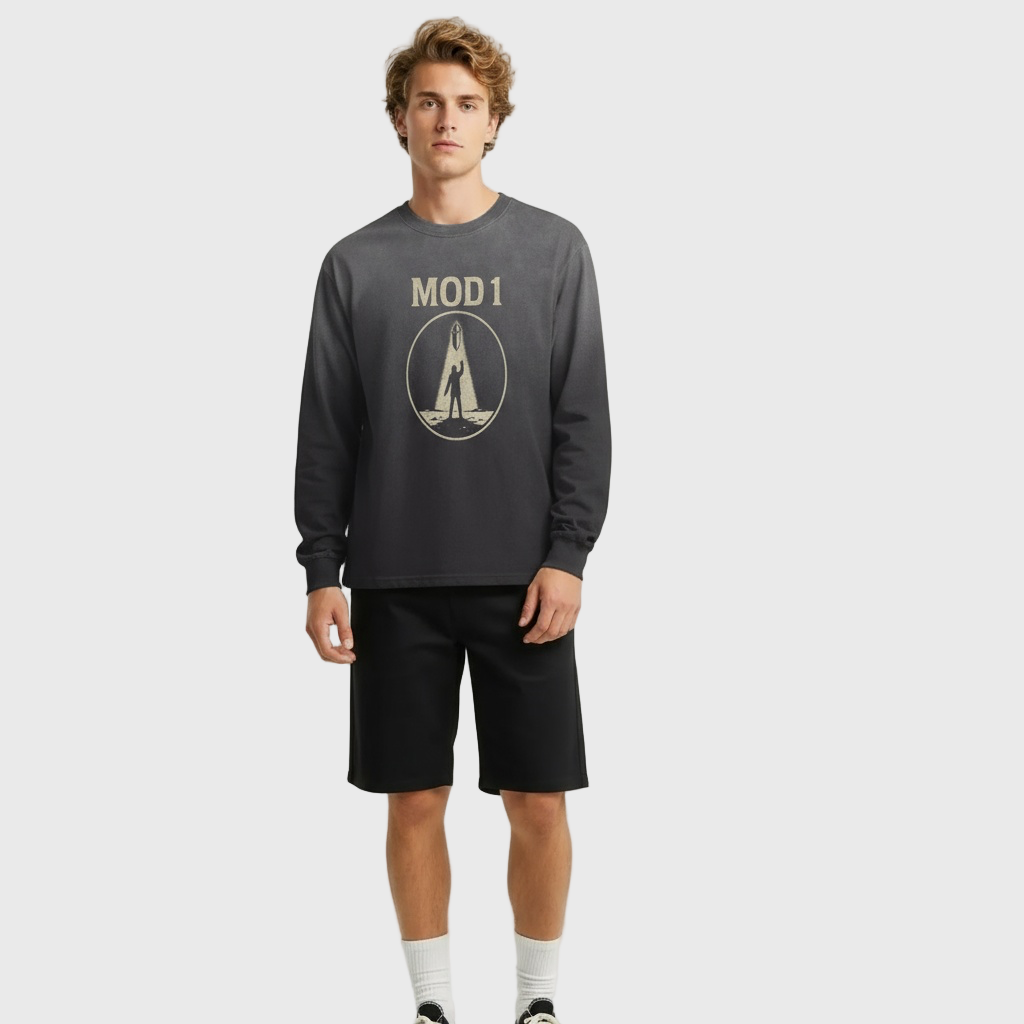 Person wearing a dark gray long-sleeve MOD 1 shirt with 'MOD 1' logo and black shorts on a light gray background