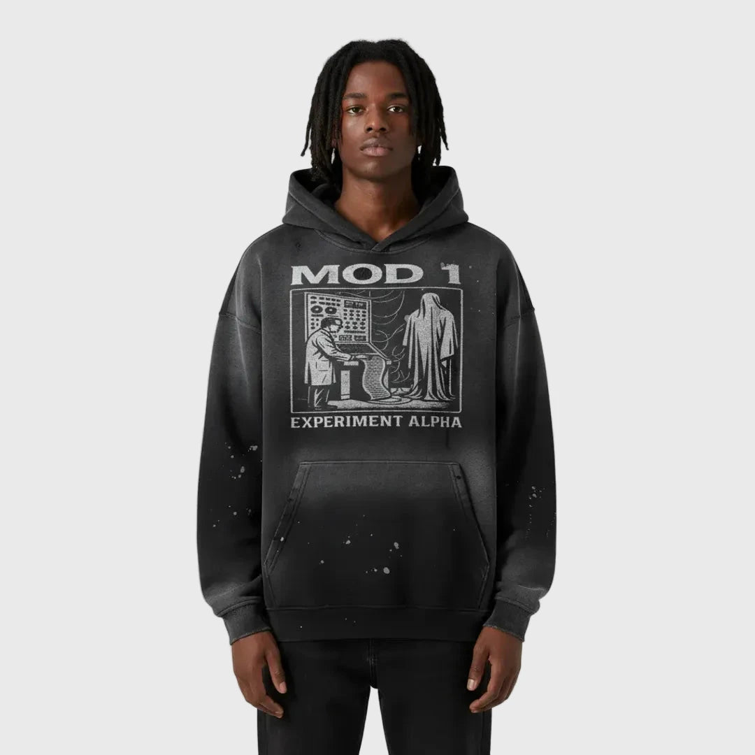 Person wearing a black MOD 1 hoodie with graphic design on a white background