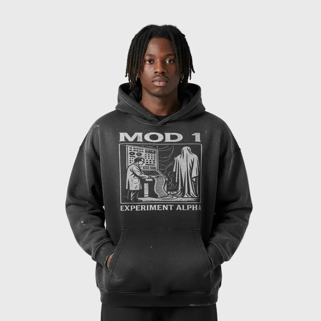 Person wearing a black and white MOD 1 hoodie with graphic design and text on a light gray background