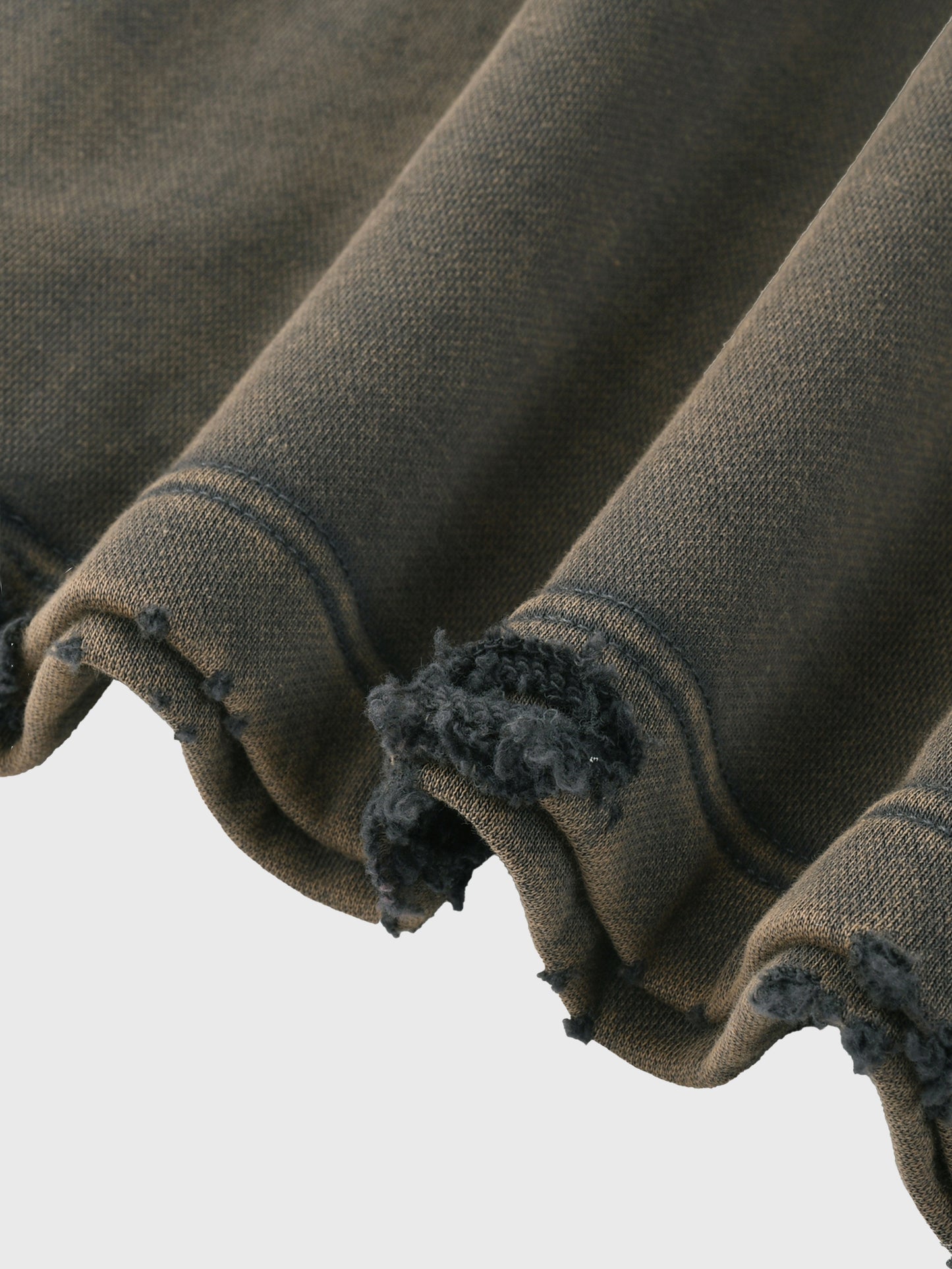 Close-up of a gray fabric with frayed edges on a light gray  background