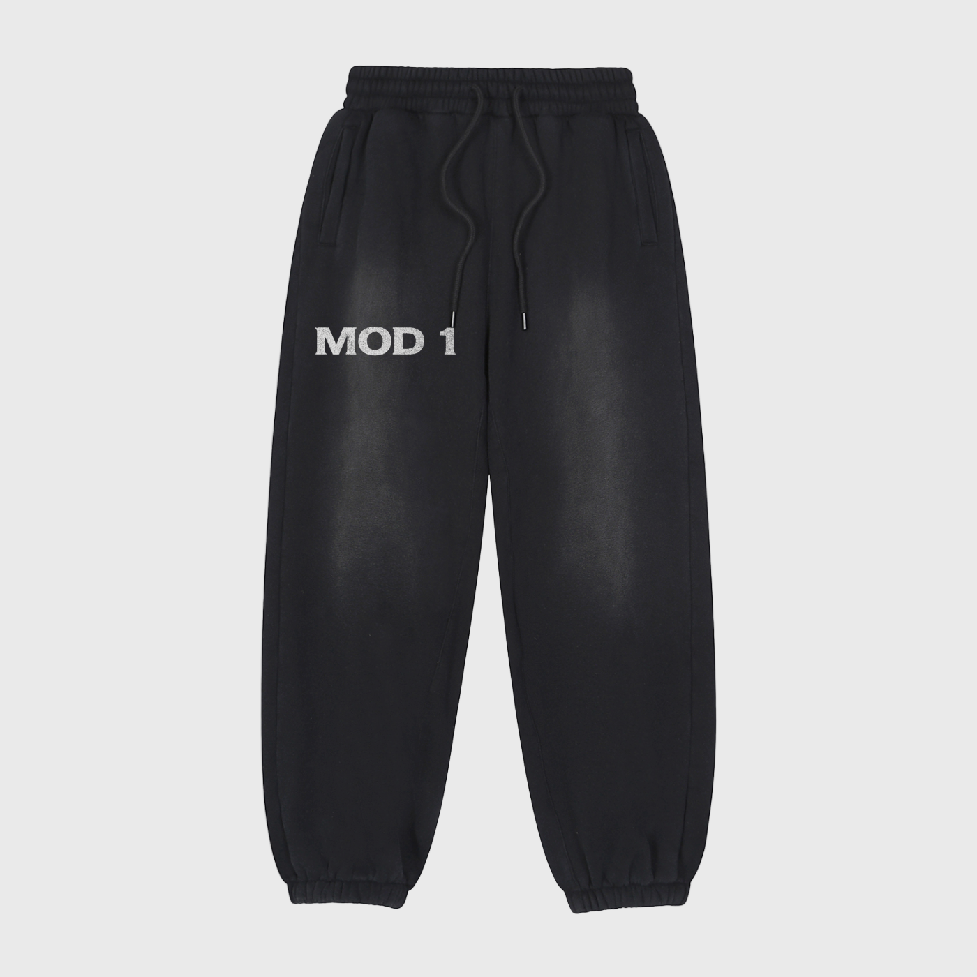 Black MOD 1 sweatpants with 'MOD 1' text on a light gray background