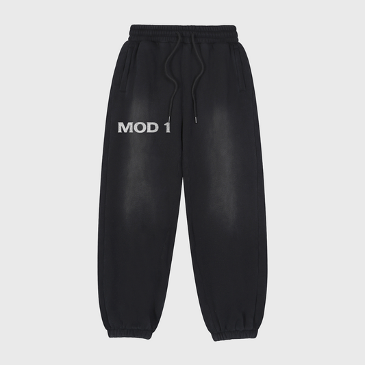Black MOD 1 sweatpants with 'MOD 1' text on a light gray background