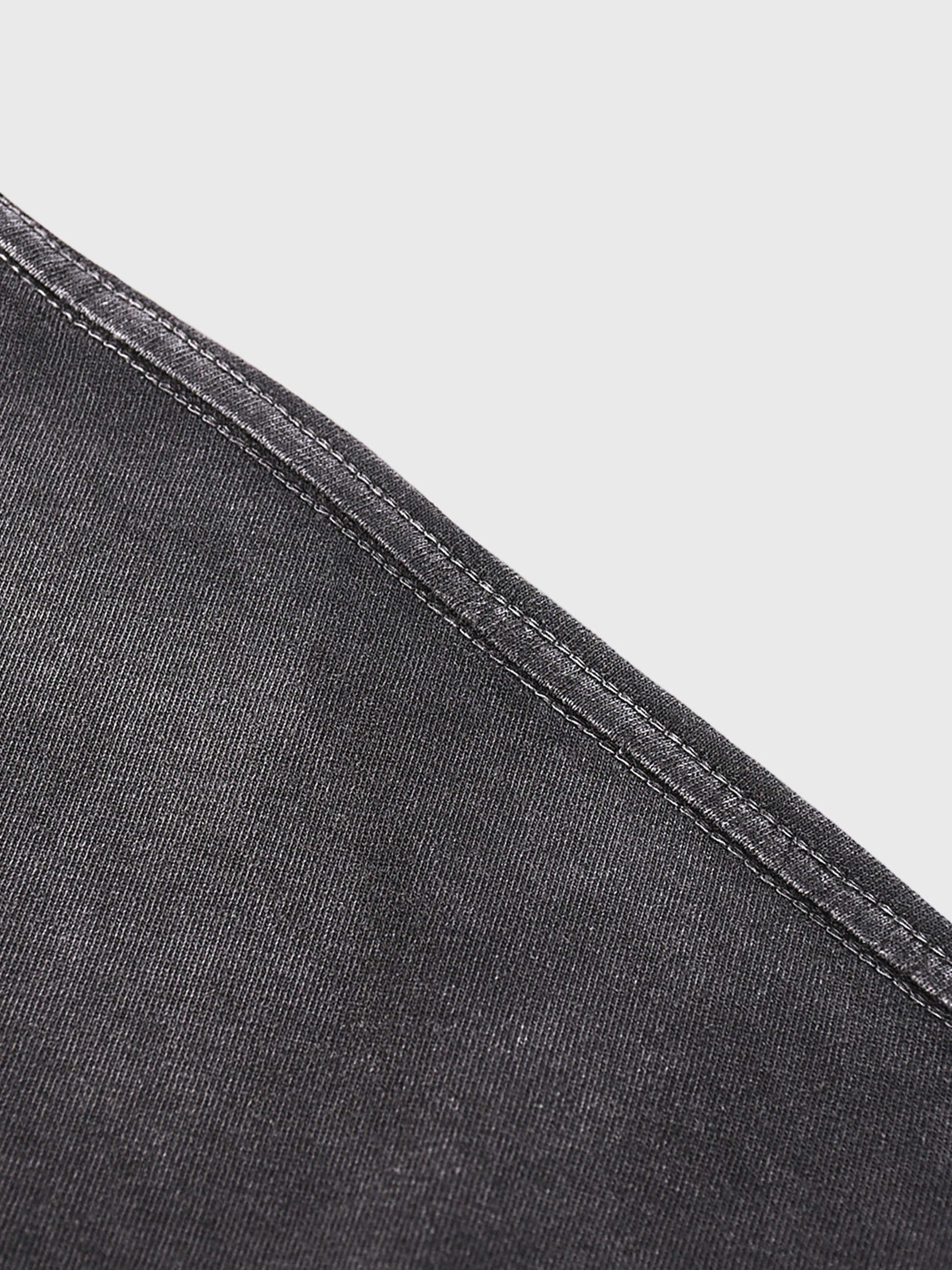 Close-up of black denim fabric with a white background
