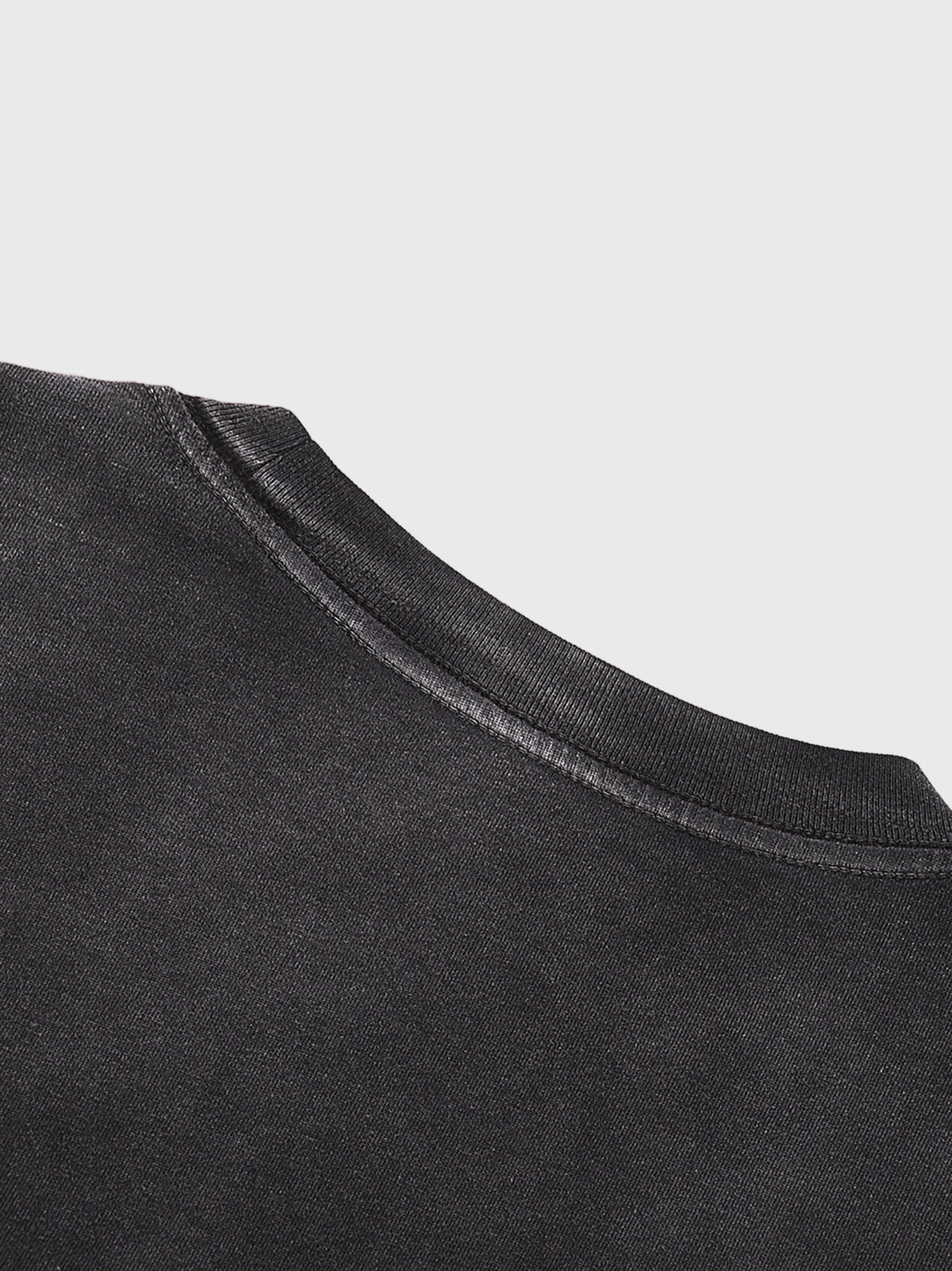 Close-up of a black garment with a light gray background