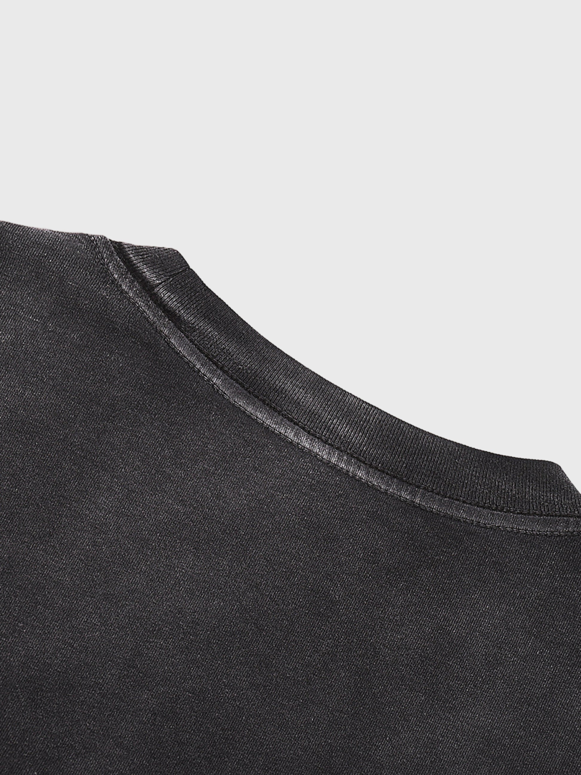 Close-up of a black garment with a light gray background