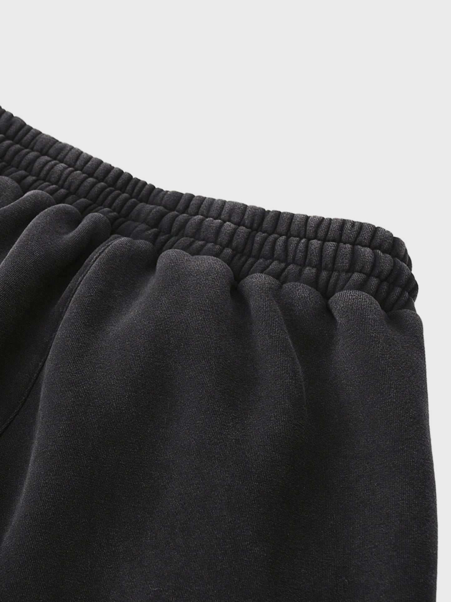 Close-up of black MOD 1 sweatpants with a light gray background