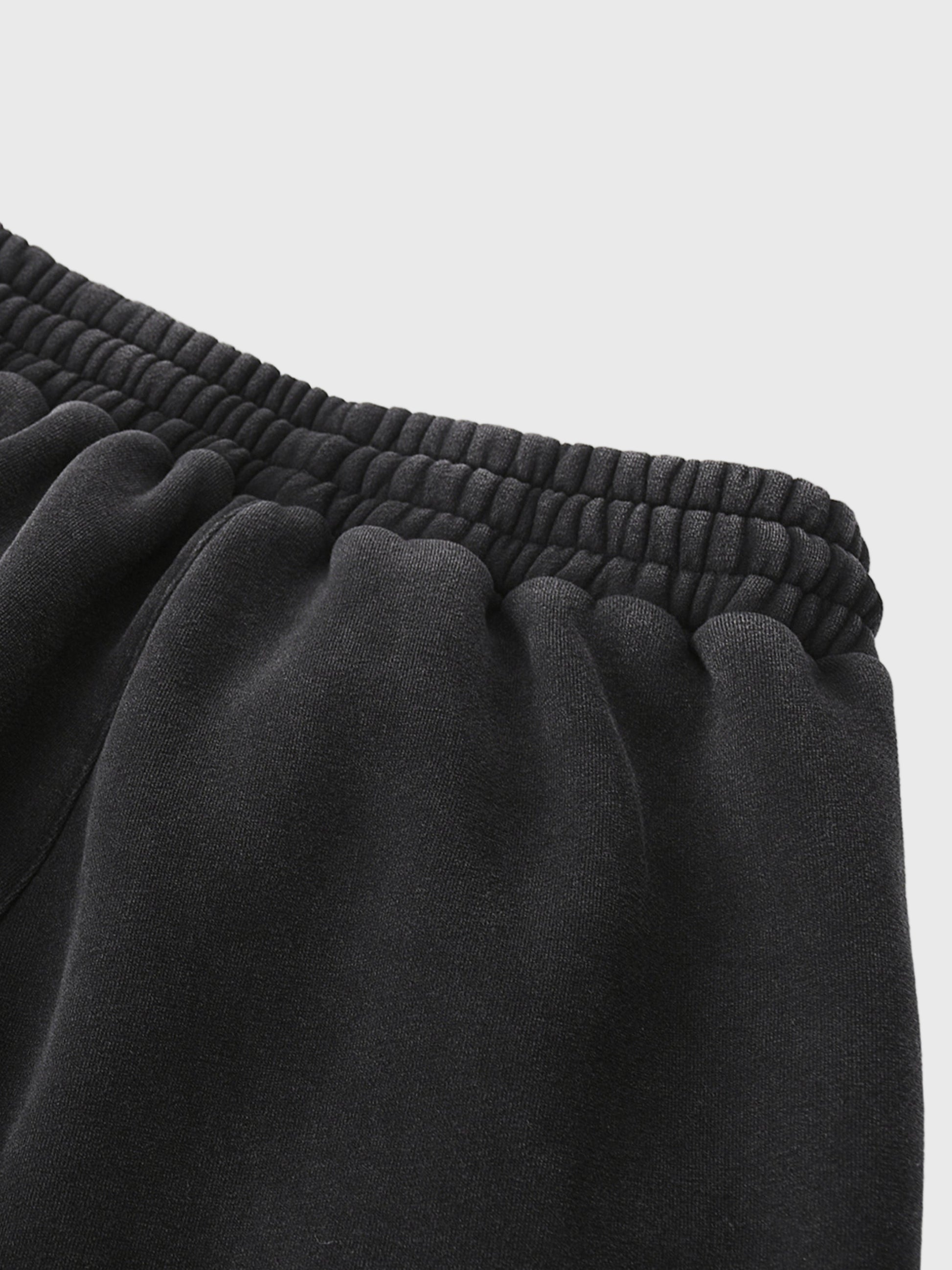 Close-up of black MOD 1 sweatpants with a light gray background