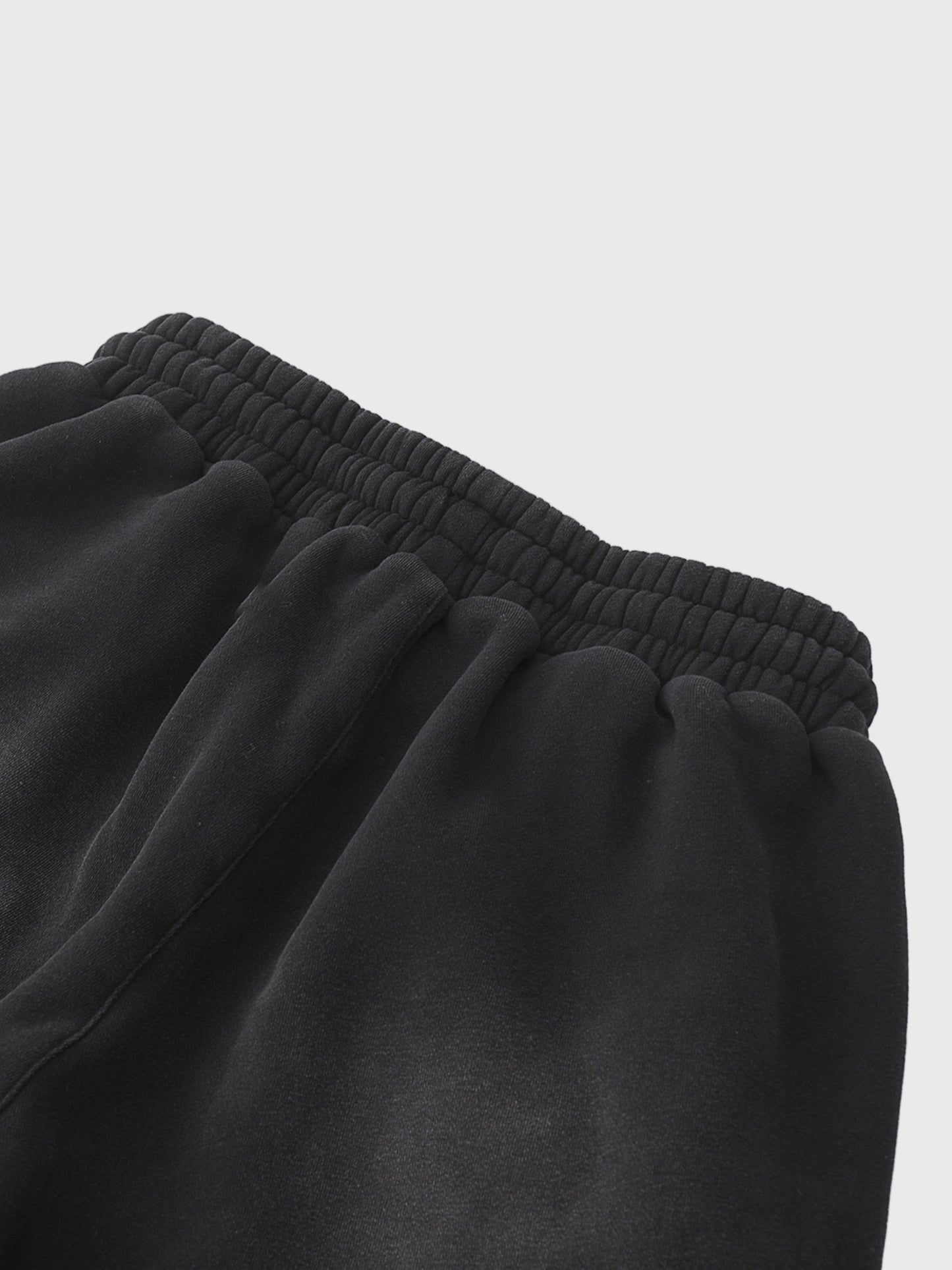 Close-up of black MOD 1 sweatpants on a light gray  background