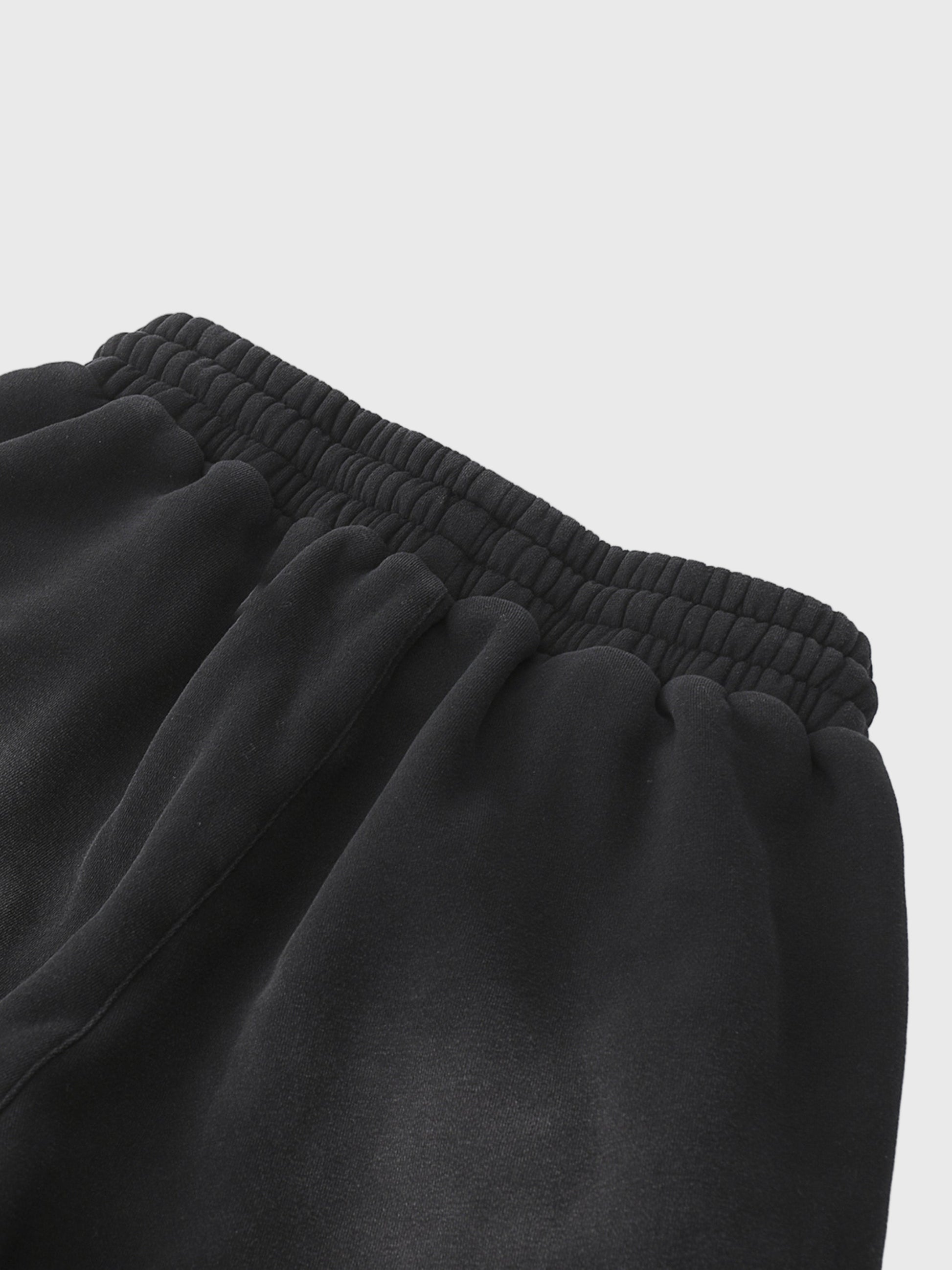 Close-up of black MOD 1 sweatpants on a light gray  background