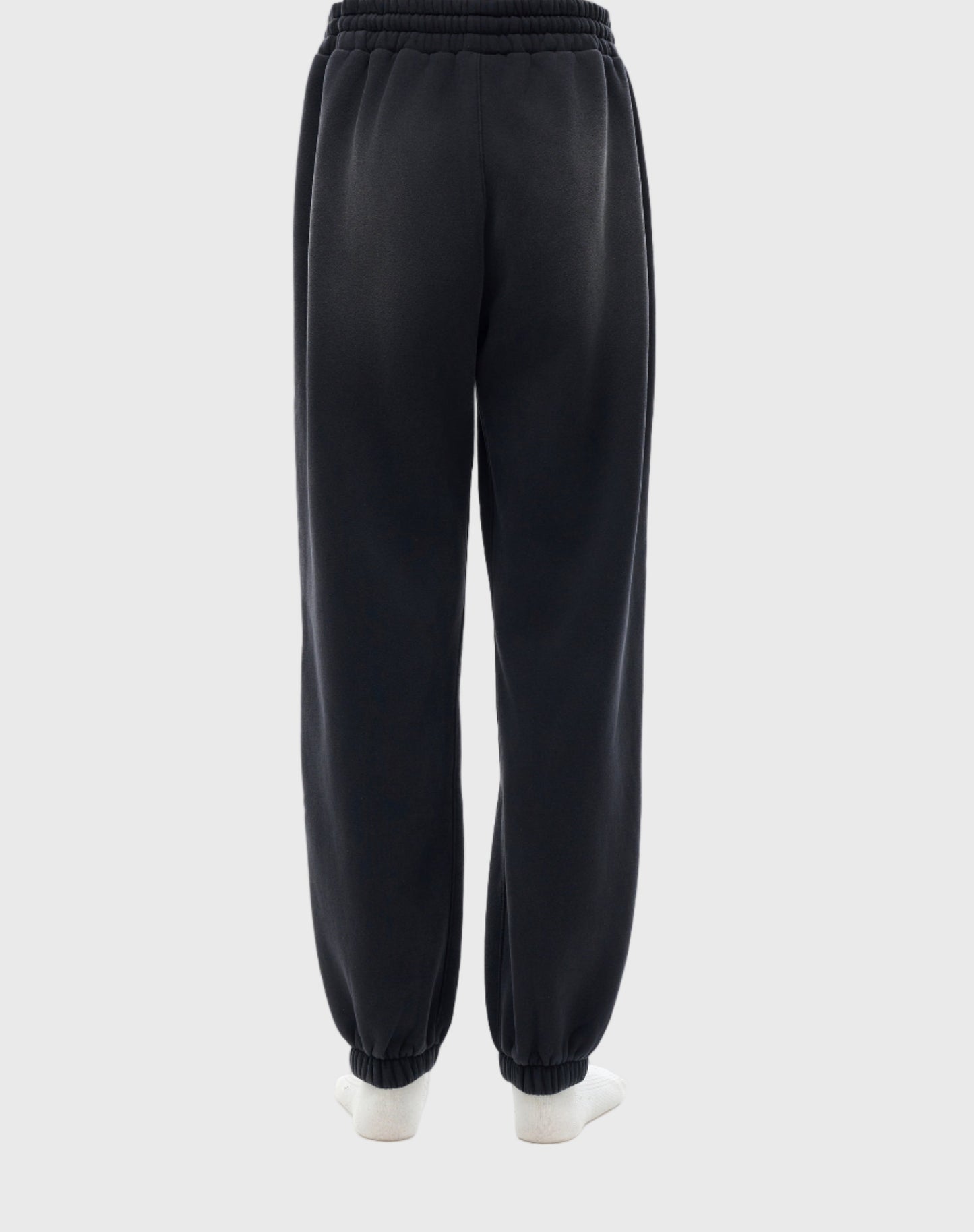 Black MOD 1 sweatpants worn by a person on a light gray background