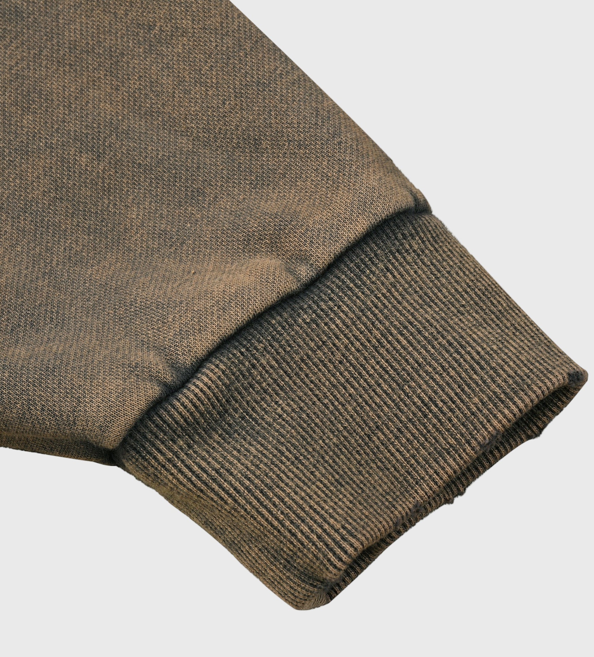 Close-up of a gray MOD 1  hoodie sleeve on a light gray background