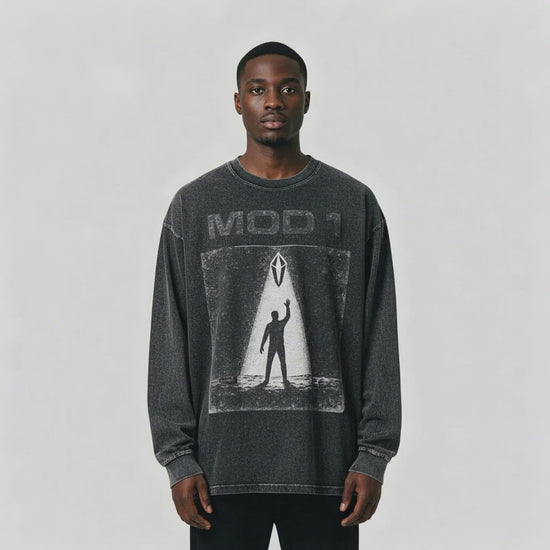 Video of African American male wearing a black MOD 1 shirt Prototype Awakening on a light gray background.