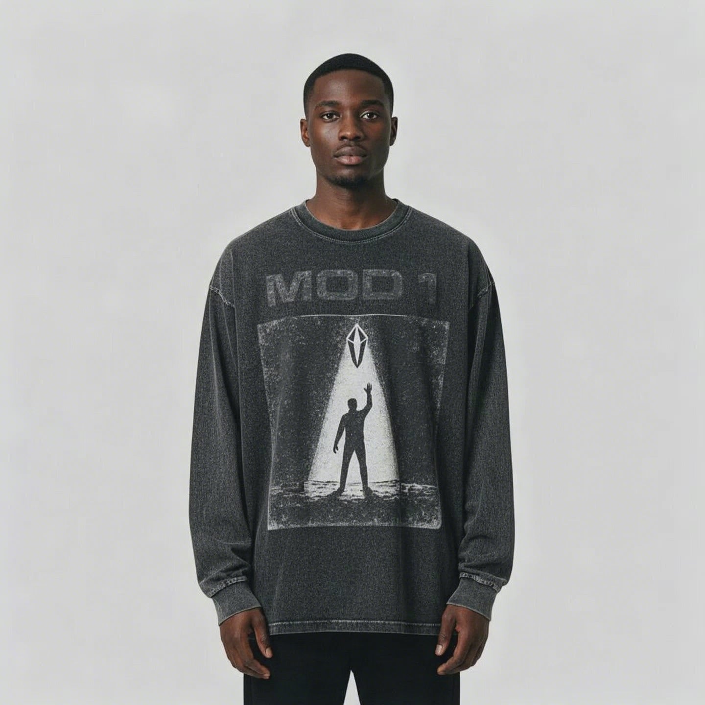 Video of African American male wearing a black MOD 1 shirt Prototype Awakening on a light gray background.